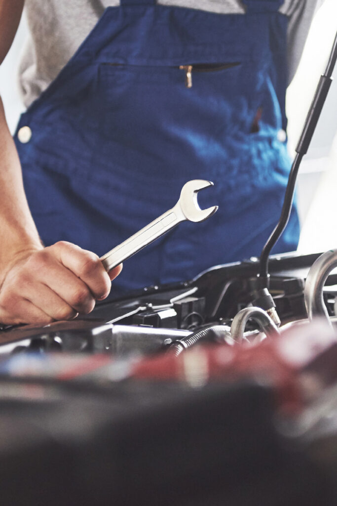 Does My Vehicle Need an MOT Yet - Thumbnail | Warrantywise Car mechanic working on engine