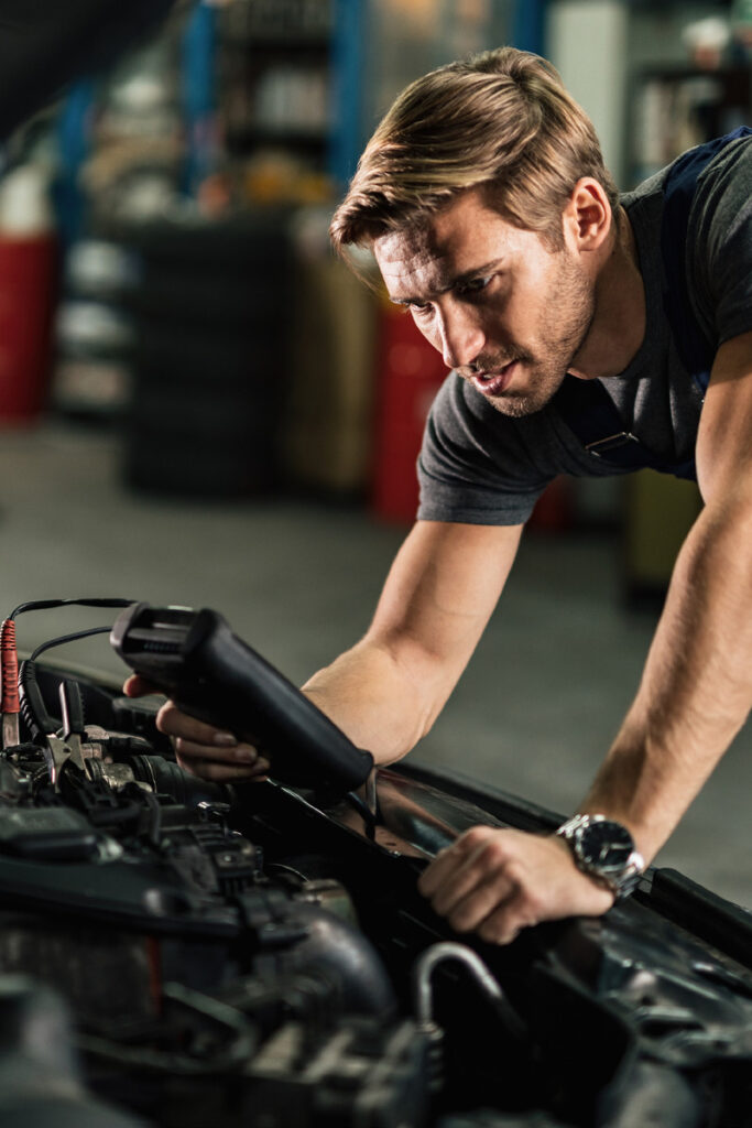 How often should I replace my car battery - Thumbnail | Warrantywise Mechanic checking battery voltage on car