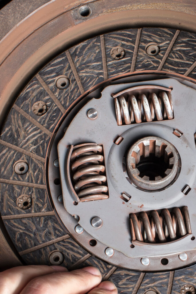 Mechanic holding clutch plate in place