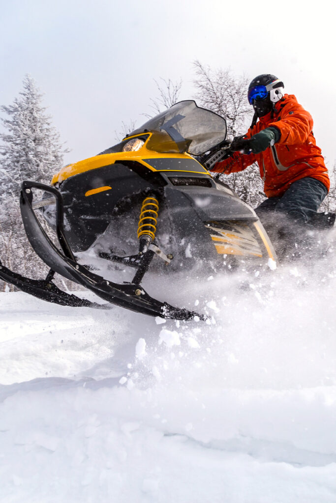 snowmobile driving through snow