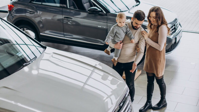 Family looking at a new car to buy