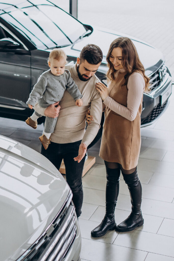 Family looking at a new car to buy