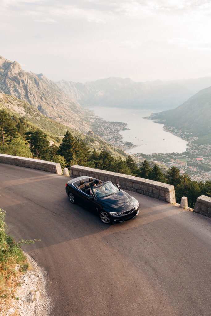 Picture of BMW on road with mountains in the background