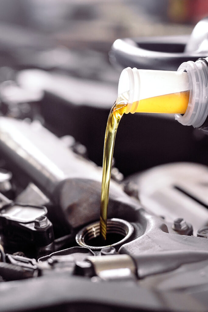 6 Essential Fluids - Thumbnail | Warrantywise Pouring oil into engine