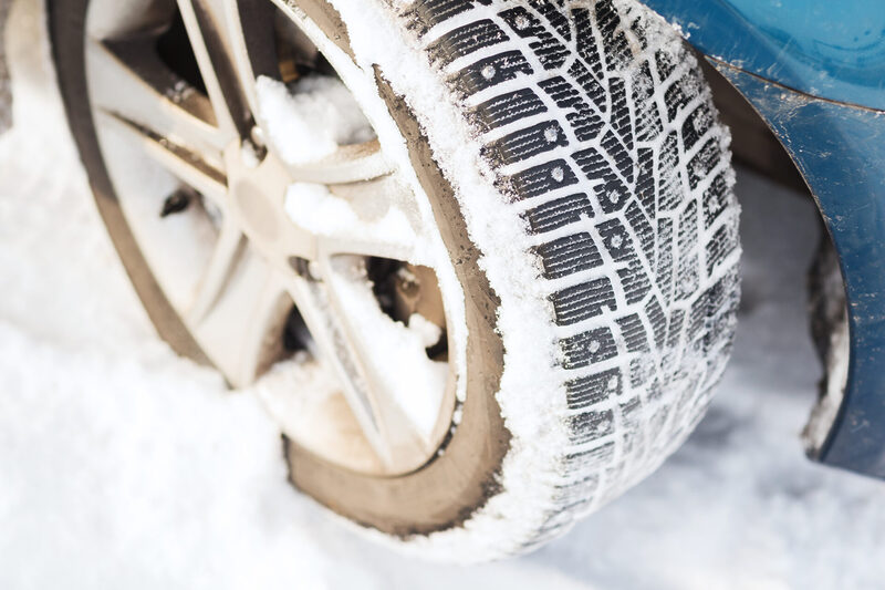 transportation-winter-and-vehicle-concept-close-2025-10-09-08-03-13-utc | Warrantywise A car tyre covered in snow showing detailed winter tread pattern.