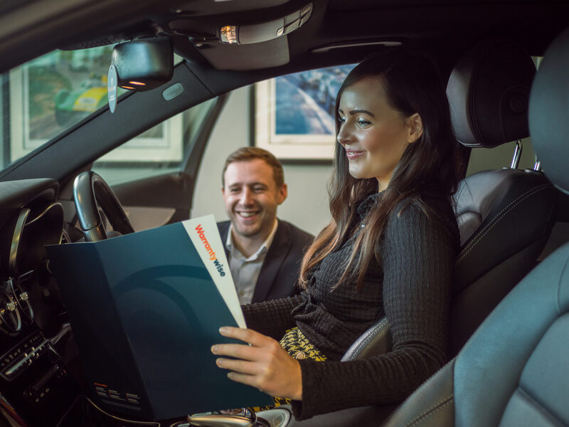 Female customer reading car brochure