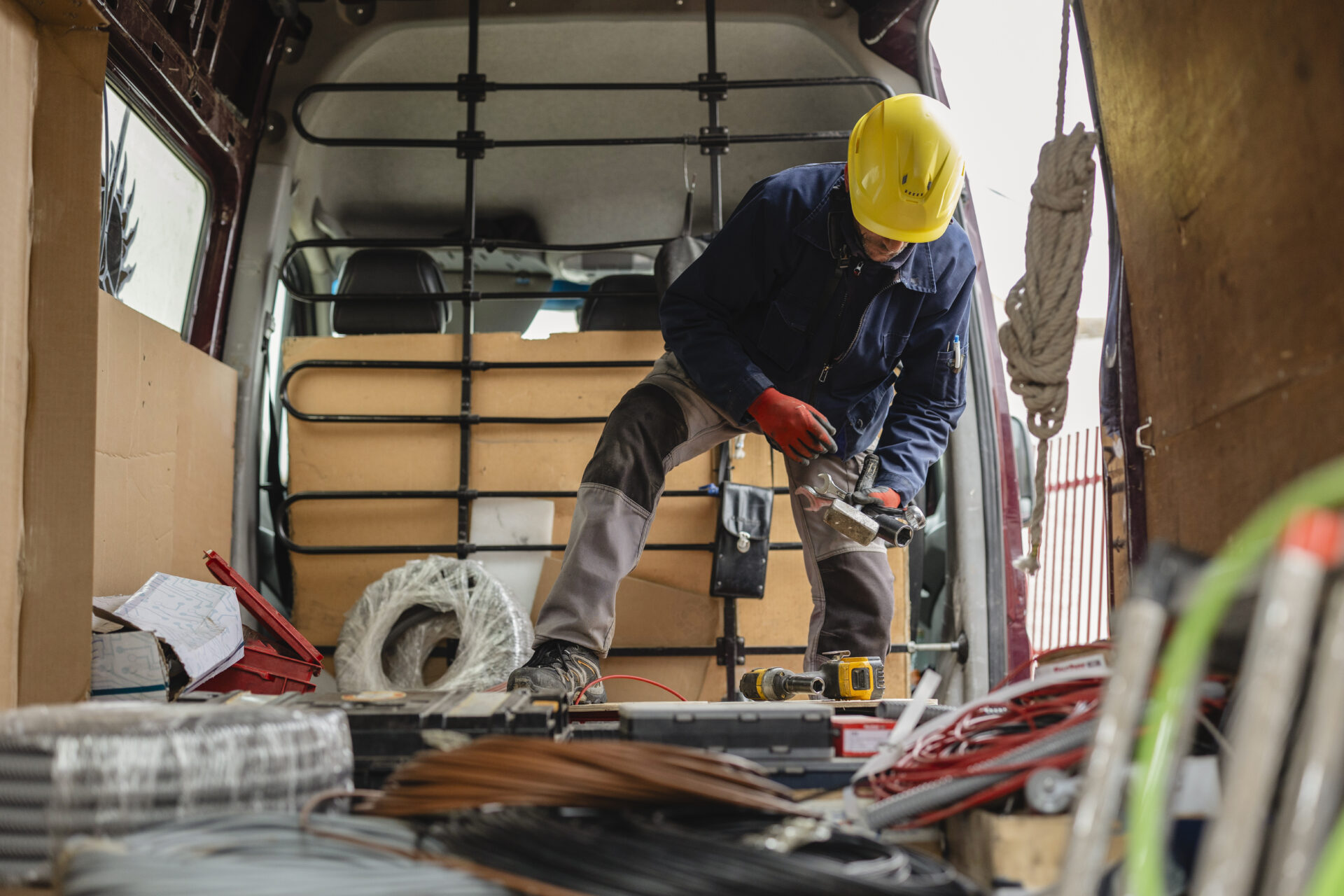 Electrician preparing cables and equipment in van for installation | Warrantywise