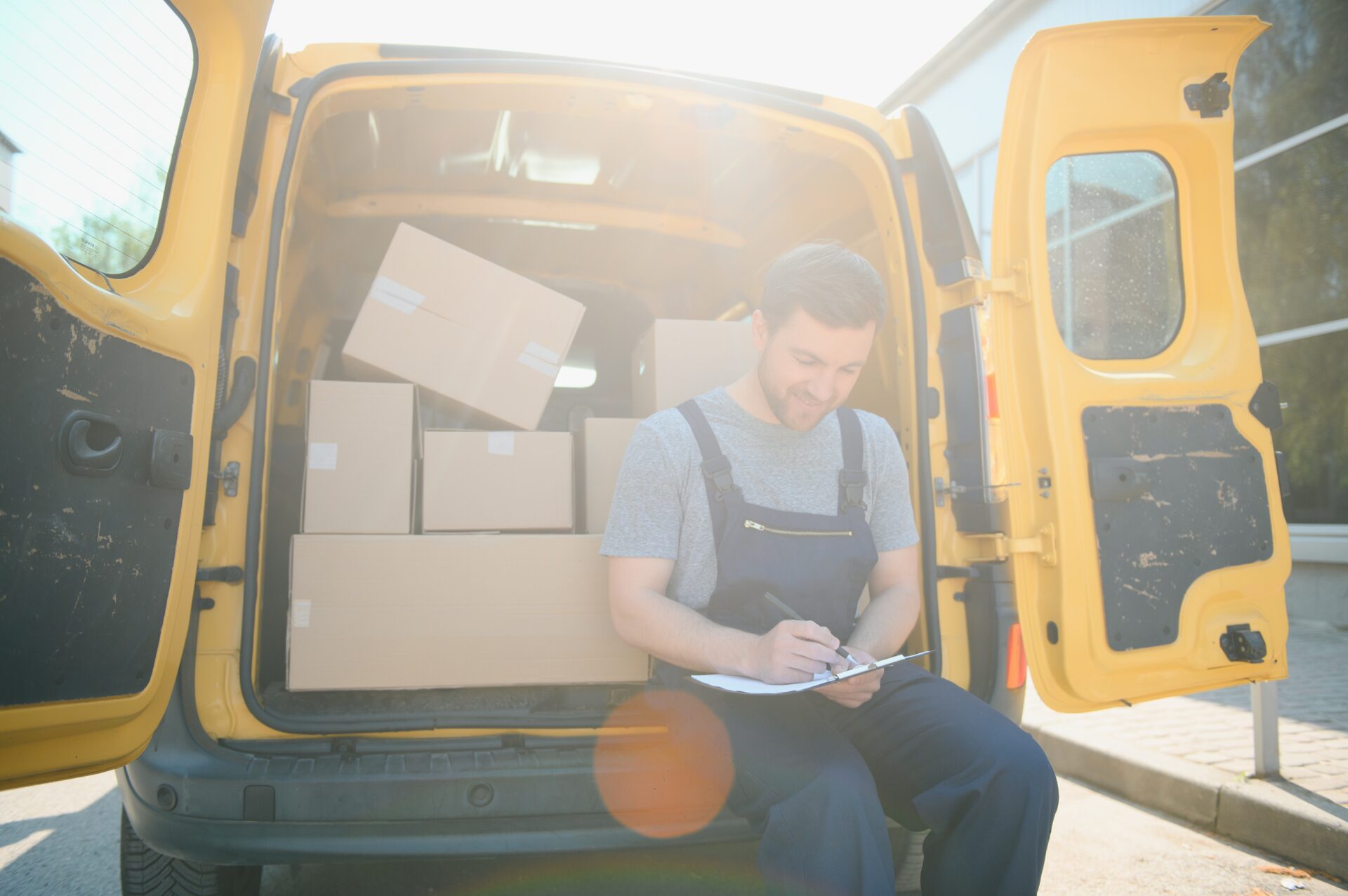 Courier service for the delivery of goods Express service a man in a uniform delivers boxes The employee carries the order home to the client | Warrantywise