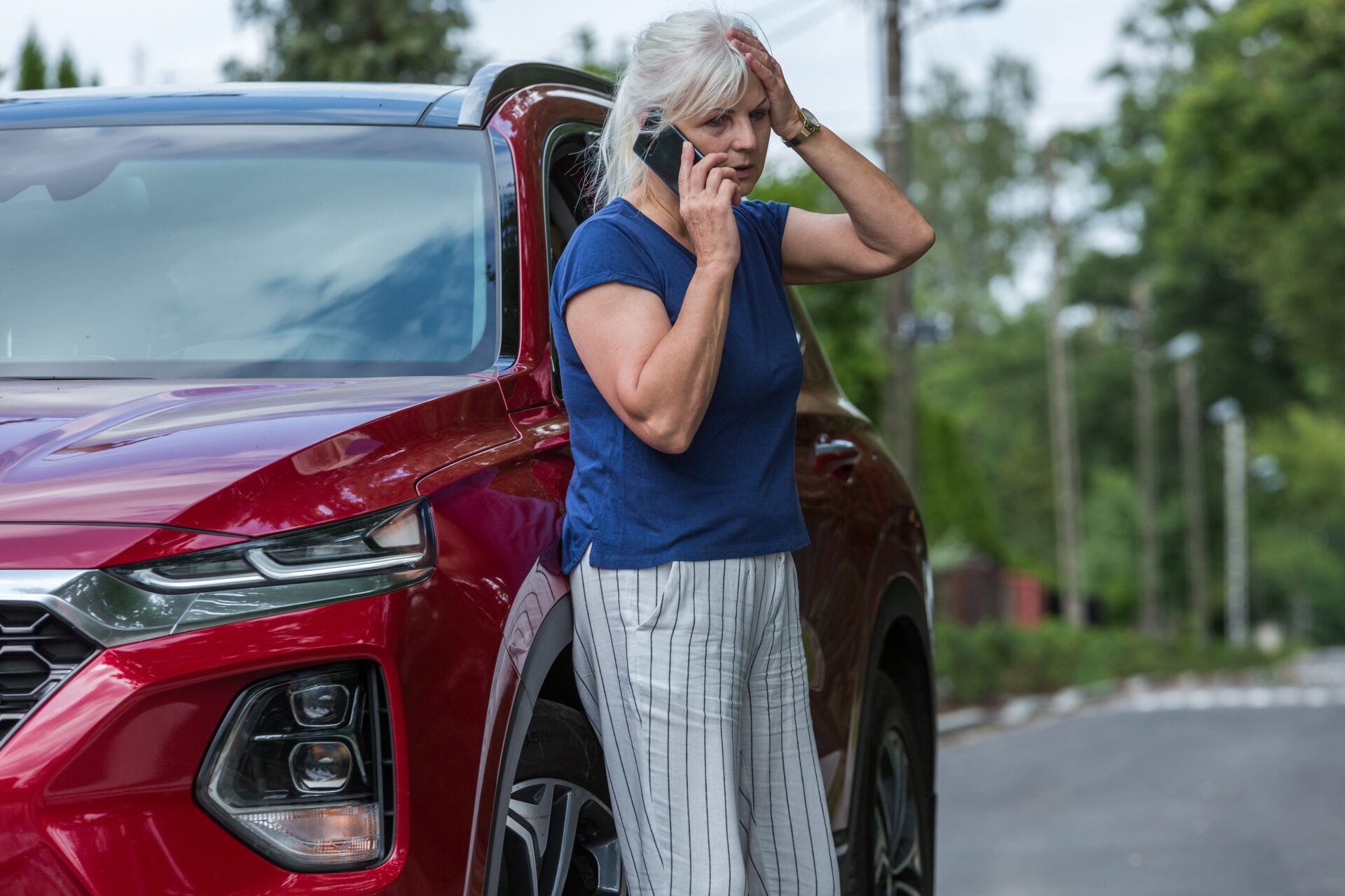 senior-woman-leans-against-her-red-car-and-calls-f-2025-10-03-23-49-15-utc | Warrantywise