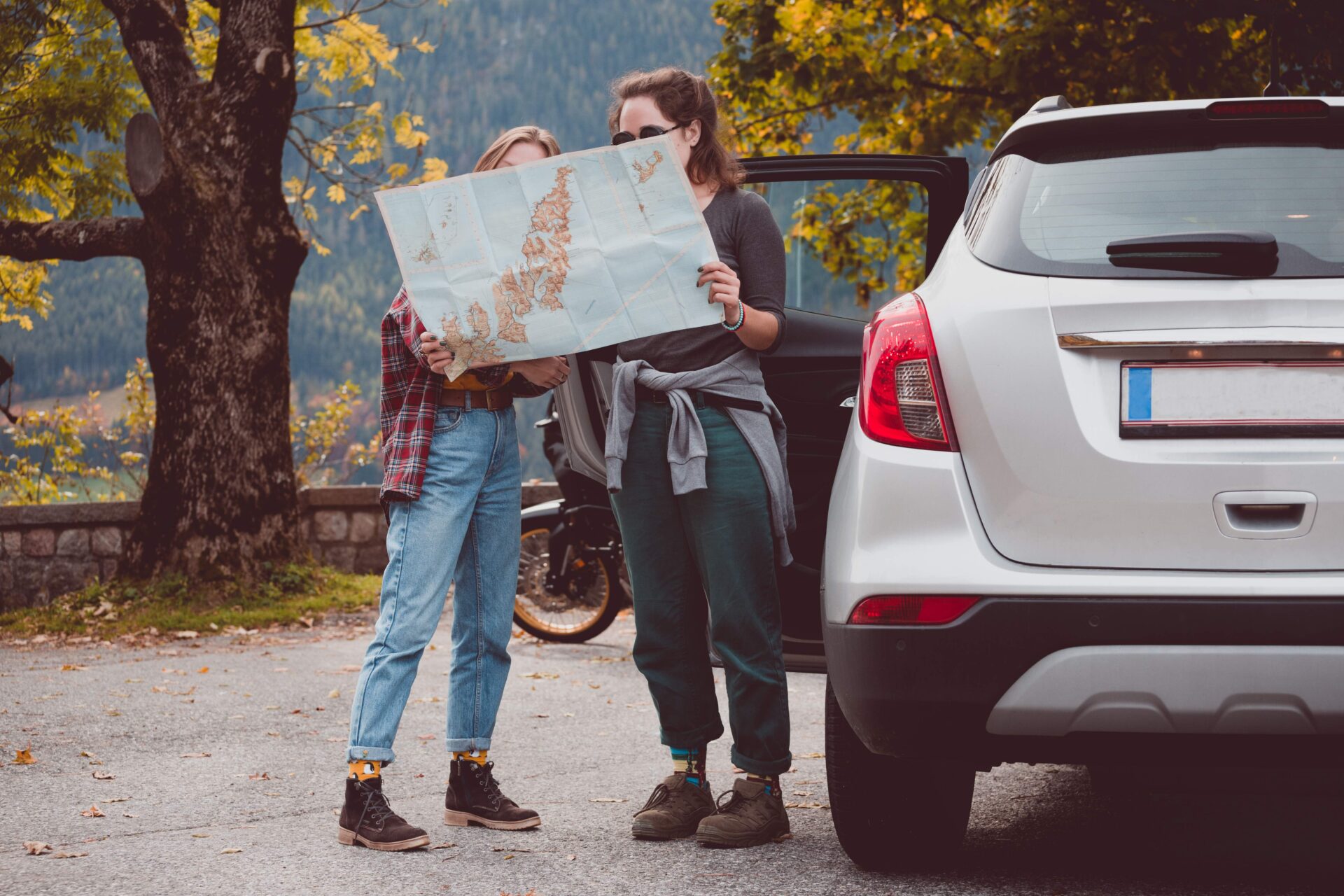 happy-girls-travel-by-car-road-trip-tourist-gir-2026-01-11-08-54-42-utc 1 | Warrantywise woman and daughter looking at road map