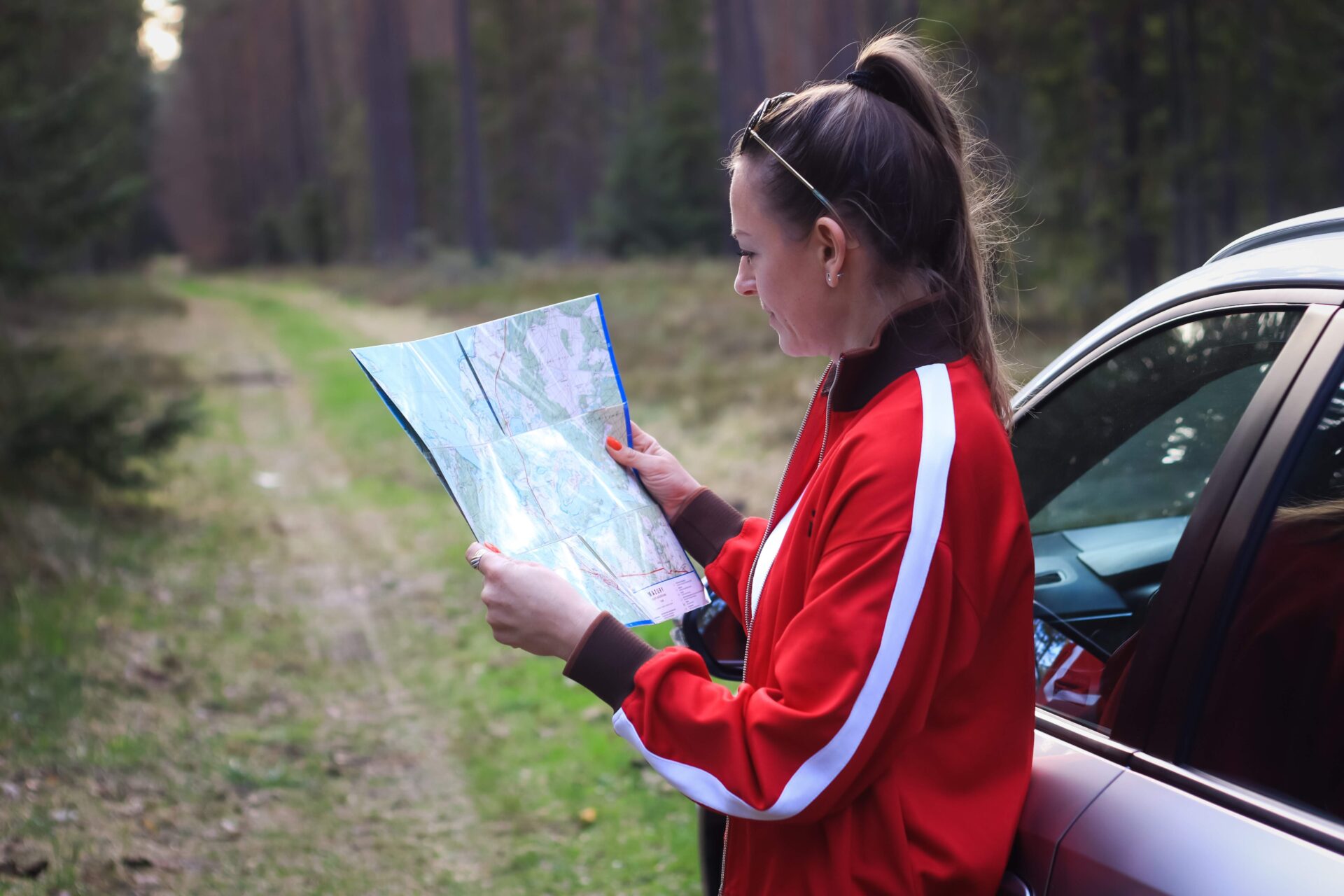 a-woman-looks-at-the-map-while-traveling-travelin-2026-01-08-07-57-31-utc 1 | Warrantywise woman looking at road map