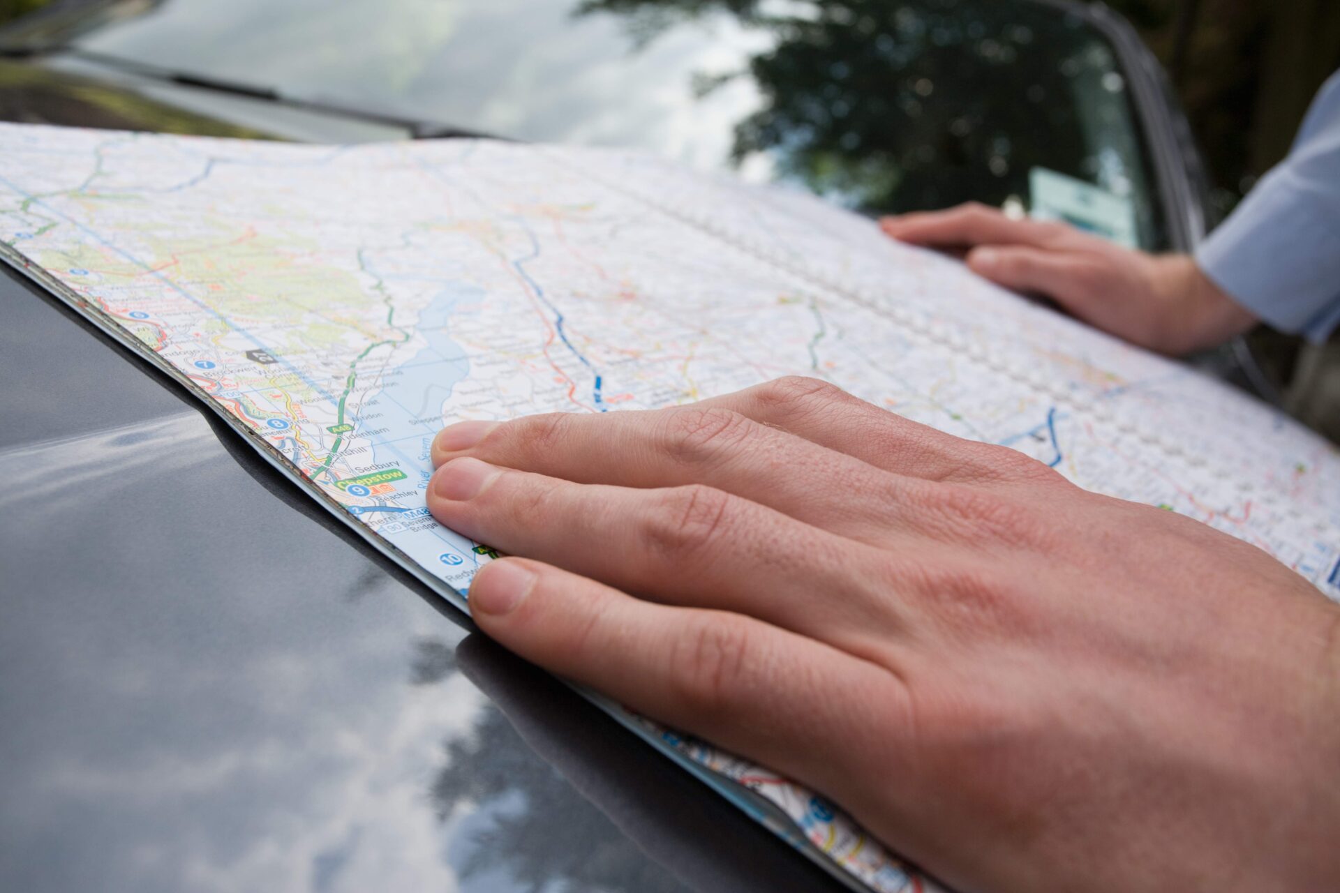 A man with a map | Warrantywise hands of man placed on road map